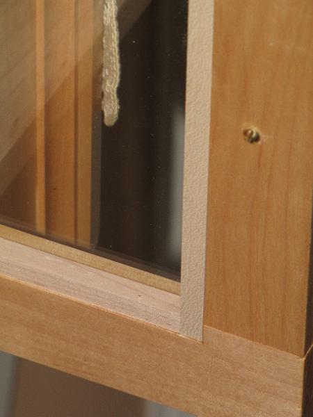 IMG_7347.JPG - The glass sits in a 3/8 wide x 1/2 deep (or so) rabbit on the back side of the door. I then used my 23ga pin-nailer to tack 3/8 x 3/8 (no glue) retainer strips in. I did not miter the corners of the retaining strips. Should the glass need to be replaced, butt joints should make it easier to remove the retainers.