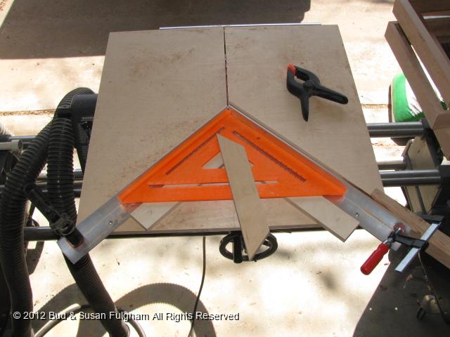 IMG_1721.JPG - Use the speed square to align the 2" aluminum angle.  F-clamp holds stop block for consistent length.  Rails must be exactly the same lenght.  Stiles must be exactly the same length.