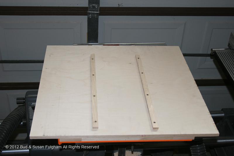 IMG_9256.JPG - Miter slot guides are installed to run in both table slots, eliminating as much 'slop' as possible.  The guides were initially set using double-sided tape and lowering the sled to the table while holding it square to the infeed side of the table.  18GA brads were used to tack them in place, then 5/8" wood screws were installed.